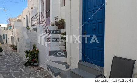 White exterior with cute paint on the steps along with cobblestone street in touristic area White exterior with cute paint on the steps along with cobblestone street in touristic area 137120343