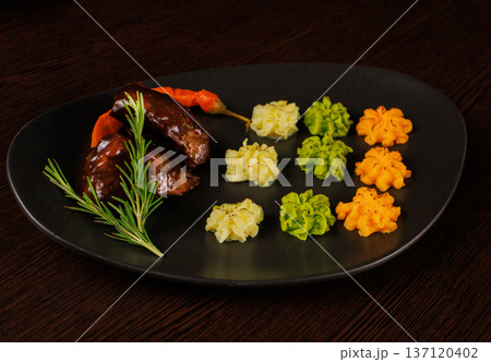 Fried meat on a plate with different sauces and 137120402