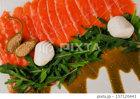 A plate with sliced red fish, bread and greens A plate with sliced red fish, bread and greens 137120441