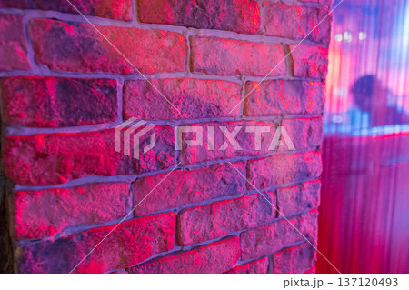 A wall illuminated by spotlights in a nightclub A wall illuminated by spotlights in a nightclub 137120493
