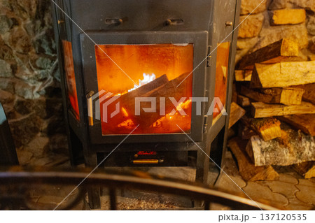 A burning iron fireplace in a cozy cafe 137120535