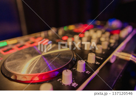 A DJ booth in the evening lights of a club A DJ booth in the evening lights of a club 137120546
