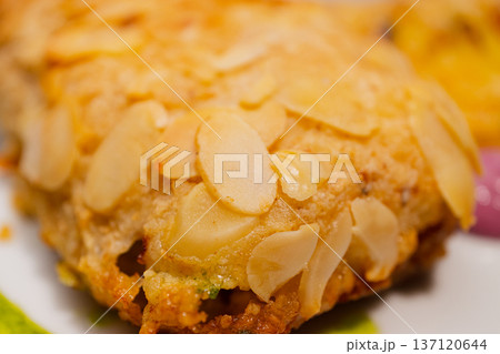 Chicken cutlets sprinkled with almonds on a white 137120644