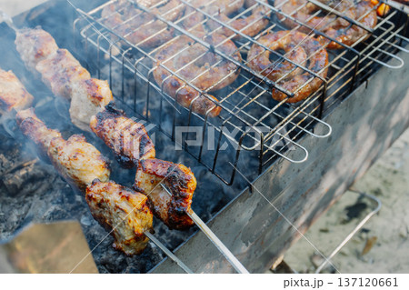 Kebabs and sausages are being grilled on the grill Kebabs and sausages are being grilled on the grill 137120661
