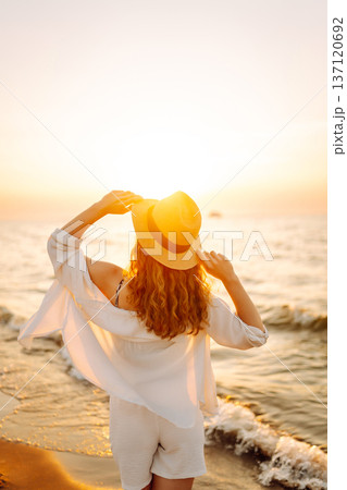 Happy woman on beach in summer style fashion trend outfit carefree and happy, feeling freedom. Happy woman on beach in summer style fashion trend outfit carefree and happy, feeling freedom. 137120692