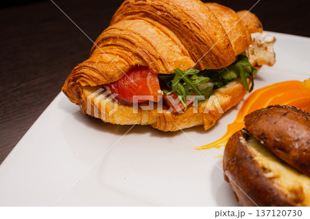 Croissant with salmon and stuffed buns on a plate Croissant with salmon and stuffed buns on a plate 137120730