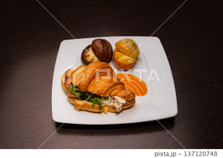 Croissant with salmon and stuffed buns on a plate Croissant with salmon and stuffed buns on a plate 137120748