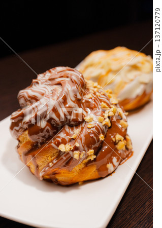Cinnabon on a white plate and on a wooden table Cinnabon on a white plate and on a wooden table 137120779