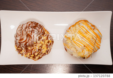 Cinnabon on a white plate and on a wooden table Cinnabon on a white plate and on a wooden table 137120788