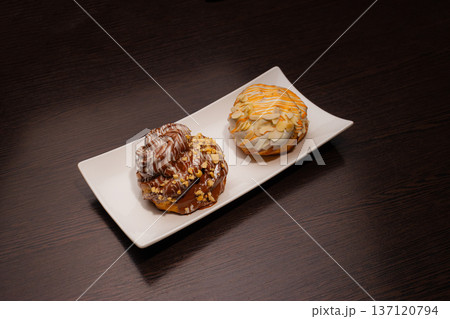 Cinnabon on a white plate and on a wooden table 137120794