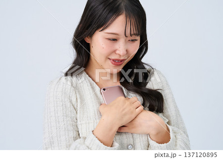 スマートフォンを持って笑顔の若い女性 スマートフォンを持って笑顔の若い女性 137120895