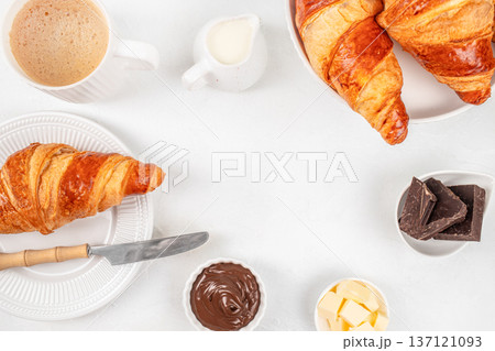 Flat Lay Croissants with Chocolate Spread, Coffee and Butter on White Background Flat Lay Croissants with Chocolate Spread, Coffee and Butter on White Background 137121093