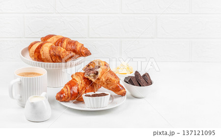Croissants with Chocolate Spread and Coffee on White Background. copy space 137121095