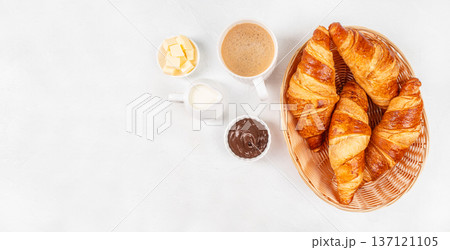 Top View Croissants Basket with Chocolate Spread, Butter and Coffee on White Background 137121105