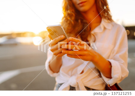 A young woman using her smartphone. Concept of vocational, blogging, technology, weekend. A young woman using her smartphone. Concept of vocational, blogging, technology, weekend. 137121255