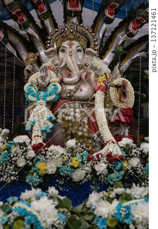 The statue of the Hindu deity Ganesha or Ganesh. He is easily recognizable by his elephant head, large belly, and four arms. 137121461