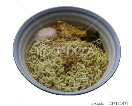 Instant noodles in spicy broth with sea bass and soft-boiled eggs topped with fried garlic. Instant noodles in spicy broth with sea bass and soft-boiled eggs topped with fried garlic. 137121472
