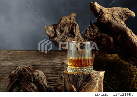 Whiskey on an old wooden stump. 137121699
