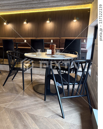 Modern cafe interior at lunchtime. Quiet seating, restaurant ambiance, urban lifestyle and social meeting place atmosphere Modern cafe interior at lunchtime. Quiet seating, restaurant ambiance, urban lifestyle and social meeting place atmosphere 137122139
