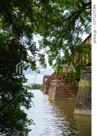 A bridge over a river with trees in the background A bridge over a river with trees in the background 137123794