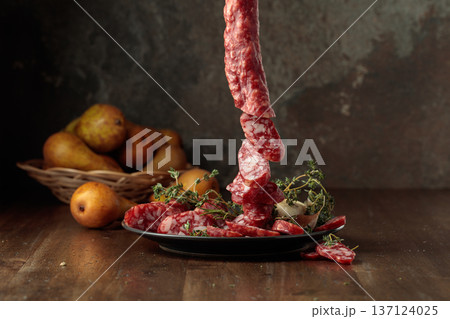 Dry-cured sausages with thyme and pears. Dry-cured sausages with thyme and pears. 137124025