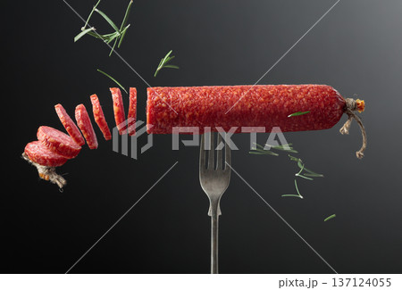 Smoked sausage on a fork. 137124055