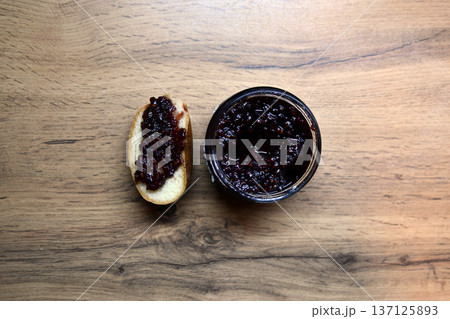 Delicious toasted bread with strawberry jam oozing out, served on a white plate. Perfect for a sweet breakfast or snack. Delicious toasted bread with strawberry jam oozing out, served on a white plate. Perfect for a sweet breakfast or snack. 137125893