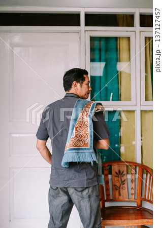 Thoughtful Man Carrying a Traditional Prayer Mat for Devotion Thoughtful Man Carrying a Traditional Prayer Mat for Devotion 137127457
