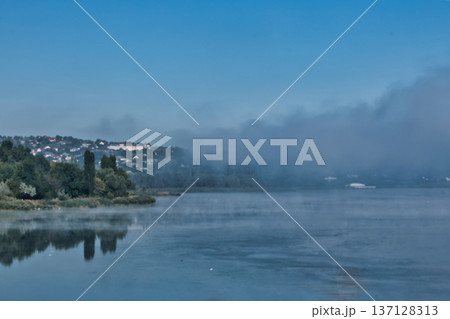 Foggy Lake Landscape with Distant Shoreline and Calm Water Foggy Lake Landscape with Distant Shoreline and Calm Water 137128313