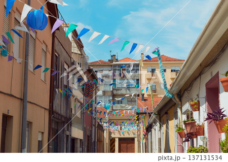 Festive bunting and lanterns decorate a narrow street for summer festival in June San Juan Festive bunting and lanterns decorate a narrow street for summer festival in June San Juan 137131534