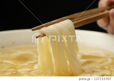 冷たいうどんを箸で持ち上げる 冷たいうどんを箸で持ち上げる 137133707