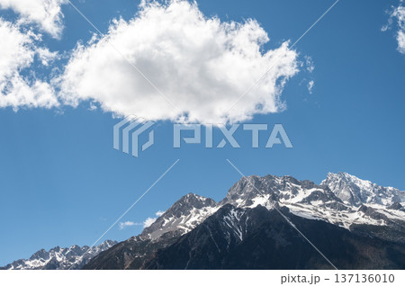 Clouds floating over Jade Dragon Snow Mountain (or Mt.Yulong) in Yulong Naxi Autonomous County, Lijiang, in Yunnan province, China. 137136010