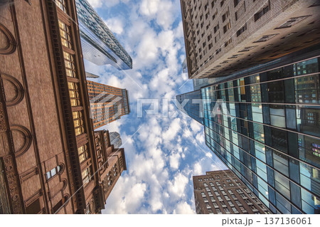 Skyscrapers viewed from below with dramatic perspective and sky between buildings in New York City Skyscrapers viewed from below with dramatic perspective and sky between buildings in New York City 137136061