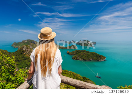Woman at viewpoint in Ang Thong Marine National Park overlooking tropical islands and turquoise sea in Thailand 137136089