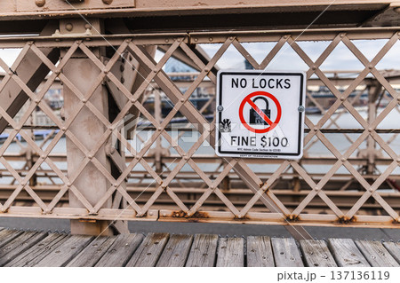 No locks warning sign on Brooklyn Bridge pedestrian walkway in New York City No locks warning sign on Brooklyn Bridge pedestrian walkway in New York City 137136119