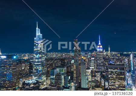 New York City skyline at night with illuminated Empire State Building and Midtown Manhattan skyscrapers 137136120