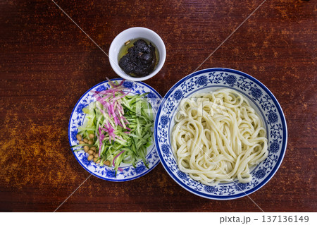 Overhead view on unmixed serving of the popular Zhajiangmian, noodle with garnish and paste in restaurant. 137136149