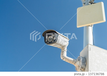 Security Camera on Pole Against Blue Sky. Video Surveillance System Outdoor. Modern Tech. Security Camera on Pole Against Blue Sky. Video Surveillance System Outdoor. Modern Tech. 137136786
