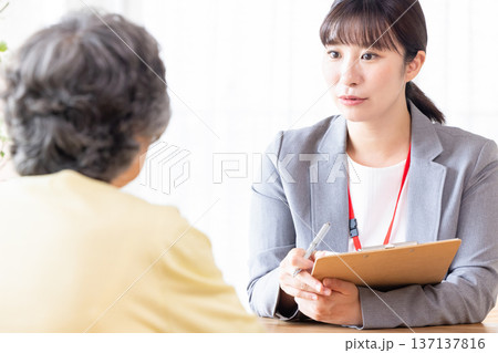シニア女性に説明するビジネスウーマン シニア女性に説明するビジネスウーマン 137137816