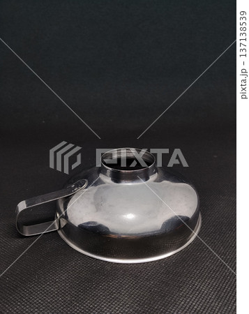 inverted aluminum funnel on a black background with space for your text 137138539