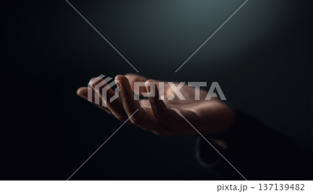 Open hand reaching in darkness. Concept of poverty, inequality, humanitarian aid 137139482