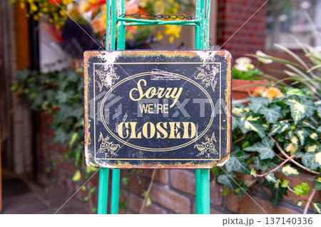 sorry we are closed sign hanging outside a restaurant, store, office or other sorry we are closed sign hanging outside a restaurant, store, office or other 137140336