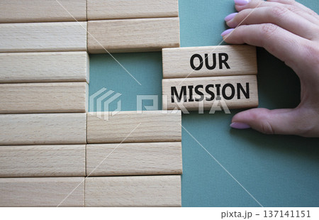 Our Mission symbol. Concept word Our Mission on wooden blocks. Businessman hand. Beautiful grey green background. Business and Our Mission concept. Copy space 137141151