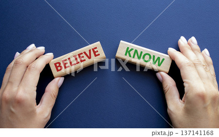 Believe or Know symbol. Concept word Believe or Know on wooden blocks. Businessman hand. Beautiful deep blue background. Business and Believe or Know concept. Copy space 137141168