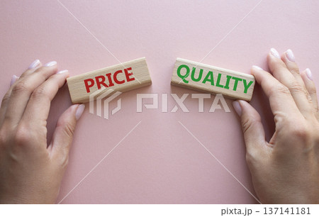 Price or Quality symbol. Concept word Price or Quality on wooden blocks. Businessman hand. Beautiful pink background. Business and Price or Quality concept. Copy space 137141181