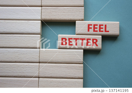 Feel better symbol. Wooden blocks with words Feel better. Beautiful grey green background. Business and Feel better concept. Copy space. Feel better symbol. Wooden blocks with words Feel better. Beautiful grey green background. Business and Feel better concept. Copy space. 137141195