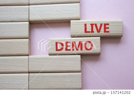 Live Demo symbol. Concept word Live Demo on wooden blocks. Beautiful pink background. Business and Live Demo concept. Copy space 137141202