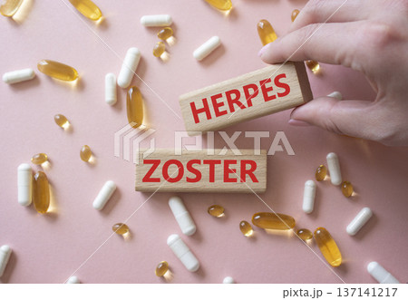 Herpes Zoster symbol. Concept word Herpes Zoster on wooden blocks. Beautiful pink background with pills. Doctor Hand. Medicine and Herpes Zoster concept. Copy space Herpes Zoster symbol. Concept word Herpes Zoster on wooden blocks. Beautiful pink background with pills. Doctor Hand. Medicine and Herpes Zoster concept. Copy space 137141217