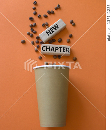 New Chapter symbol. Concept word New Chapter on wooden blocks. Beautiful orange background with coffee cup. Business and New Chapter concept. Copy space New Chapter symbol. Concept word New Chapter on wooden blocks. Beautiful orange background with coffee cup. Business and New Chapter concept. Copy space 137141228