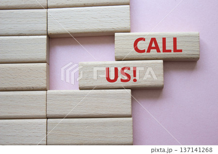 Call Us symbol. Wooden blocks with words Call Us. Beautiful pink background. Business and Call Us concept. Copy space. 137141268